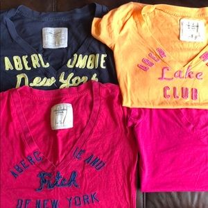 Four v neck tops, 2 pink, one navy and one orange